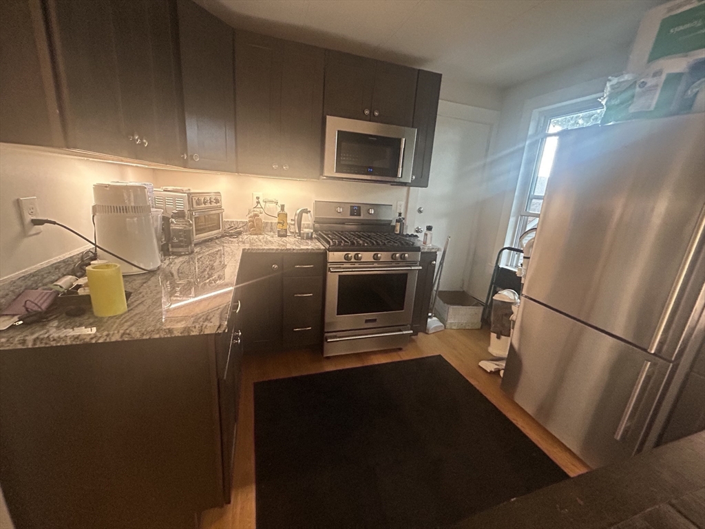 12 Pearl St Place, Unit 3 Somerville, MA 02145 - Photo 10 of 12 a kitchen with granite countertop a refrigerator and a sink