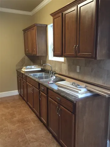 a kitchen with stainless steel appliances granite countertop a sink stove and cabinets