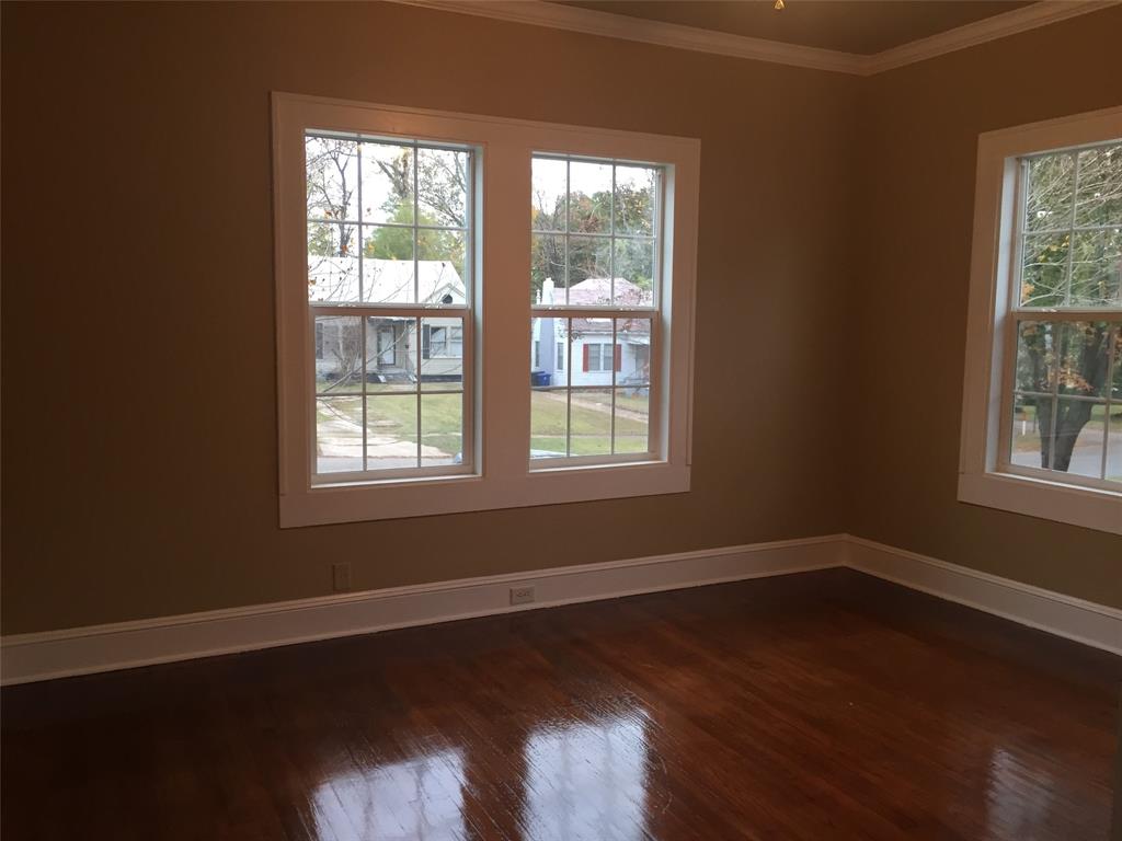 313 Merrick Street Shreveport, LA 71104 - Photo 10 of 18 a view of an empty room with wooden floor and a window