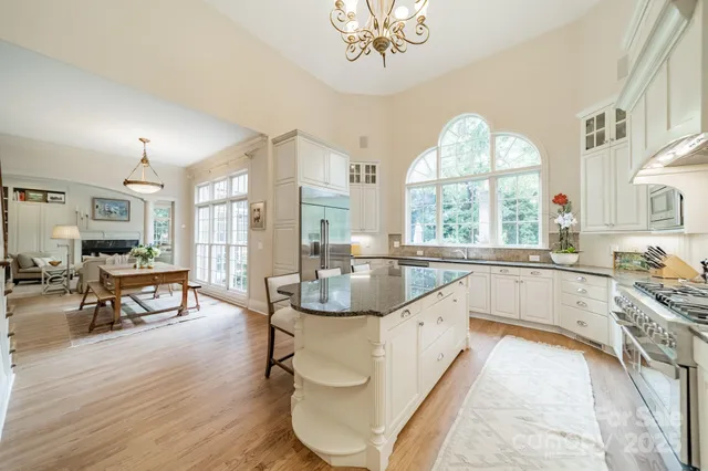 a kitchen with a stove a refrigerator and a table