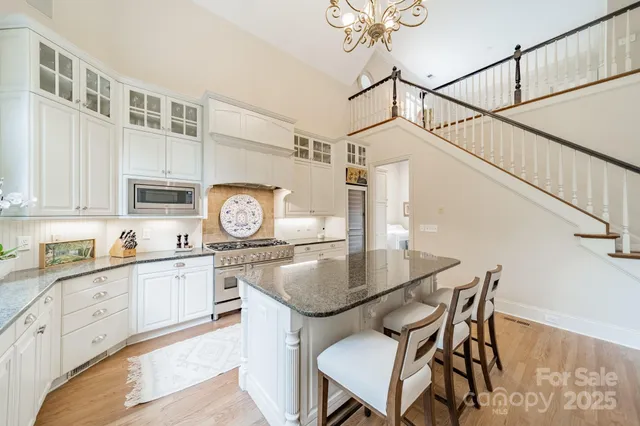 a spacious bedroom with a bed and a chandelier
