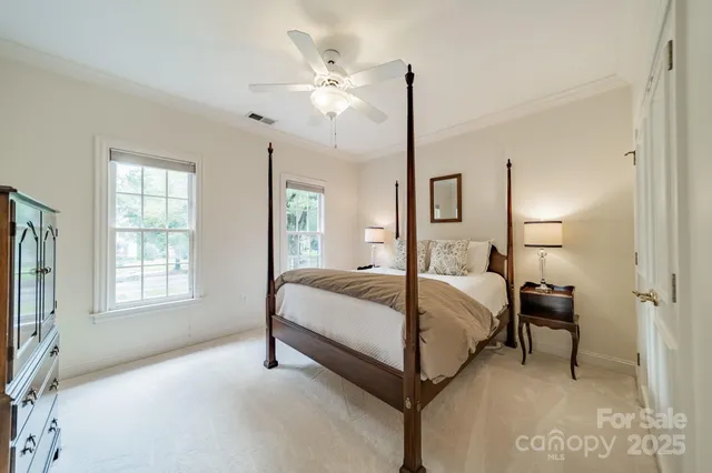 a bedroom with a bed a table and painting