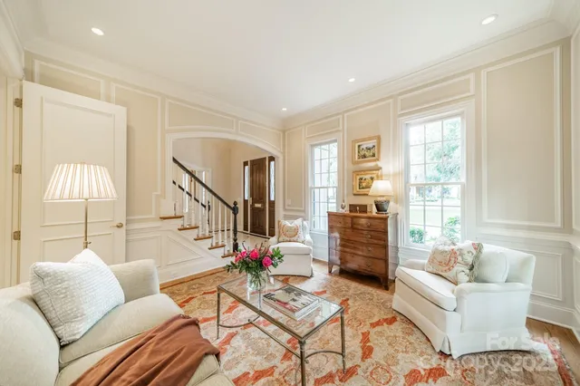 a view of a dining room with furniture and chandelier