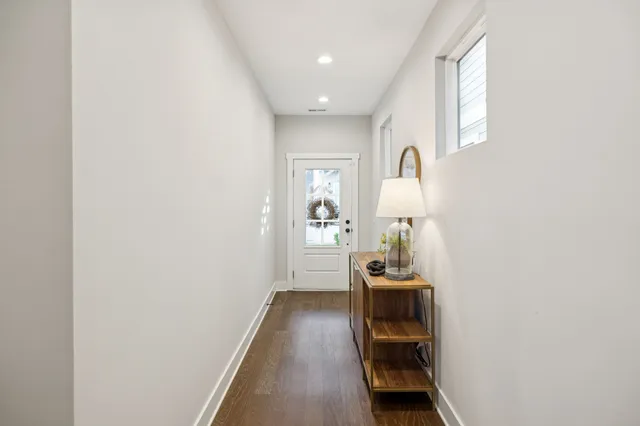 a hallway with front door wooden floor and front door