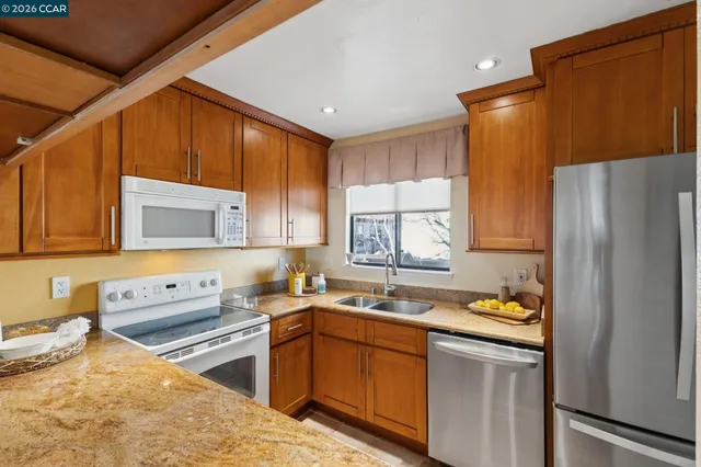 a kitchen that has a sink and a refrigerator
