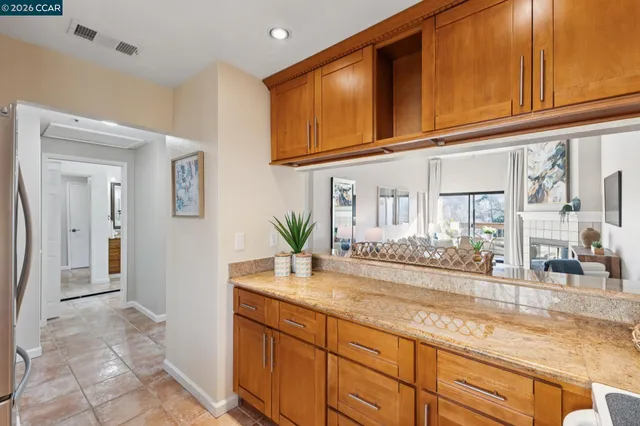 a kitchen with granite countertop a sink and cabinets
