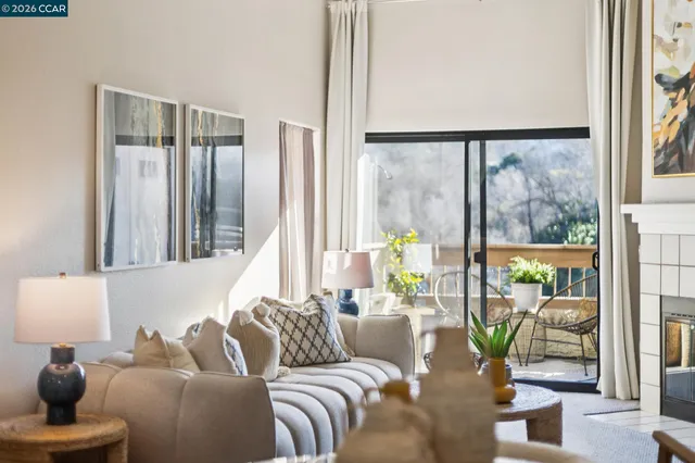 a living room with furniture and a floor to ceiling window