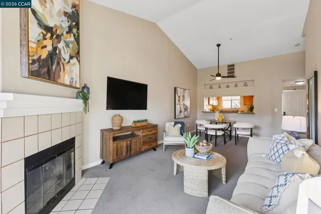 a living room with furniture a fireplace and a flat screen tv