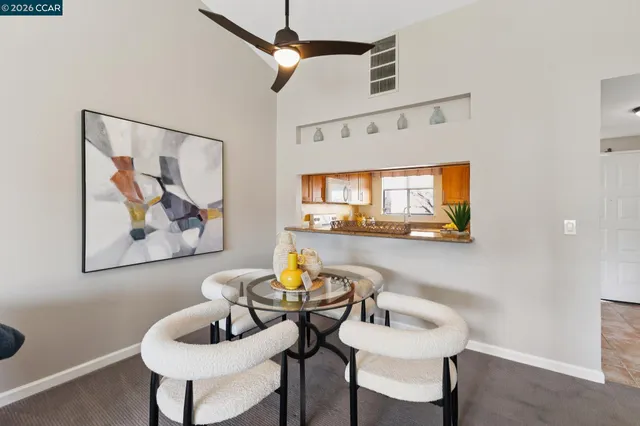 a dining room with furniture and a painting on the wall
