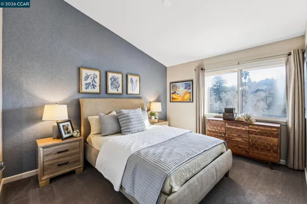 a bedroom with a bed and a large window
