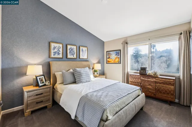 a bedroom with a bed and a large window