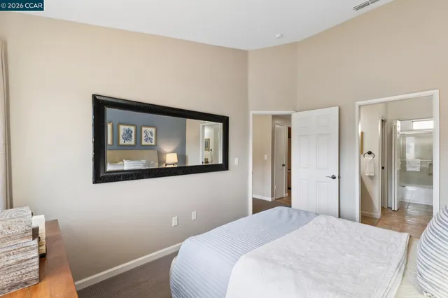 a bedroom with a bed and a mirror