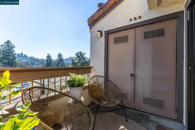 a view of a balcony with furniture and garden