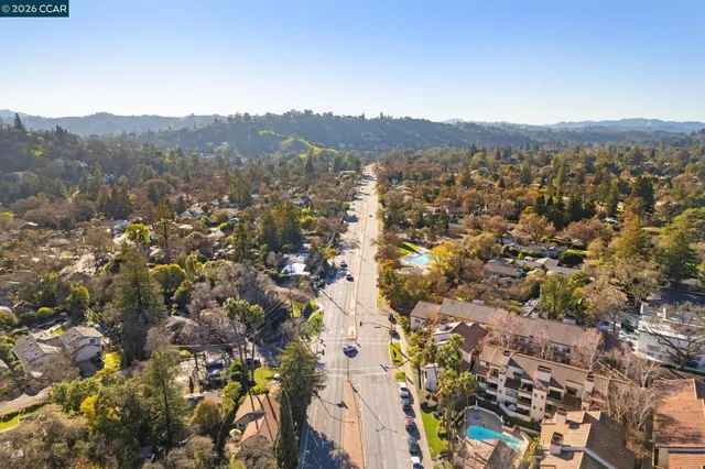 an aerial view of residential houses with city view