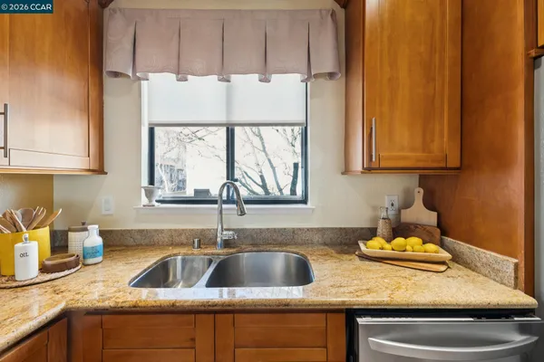 a kitchen with a sink cabinets and window