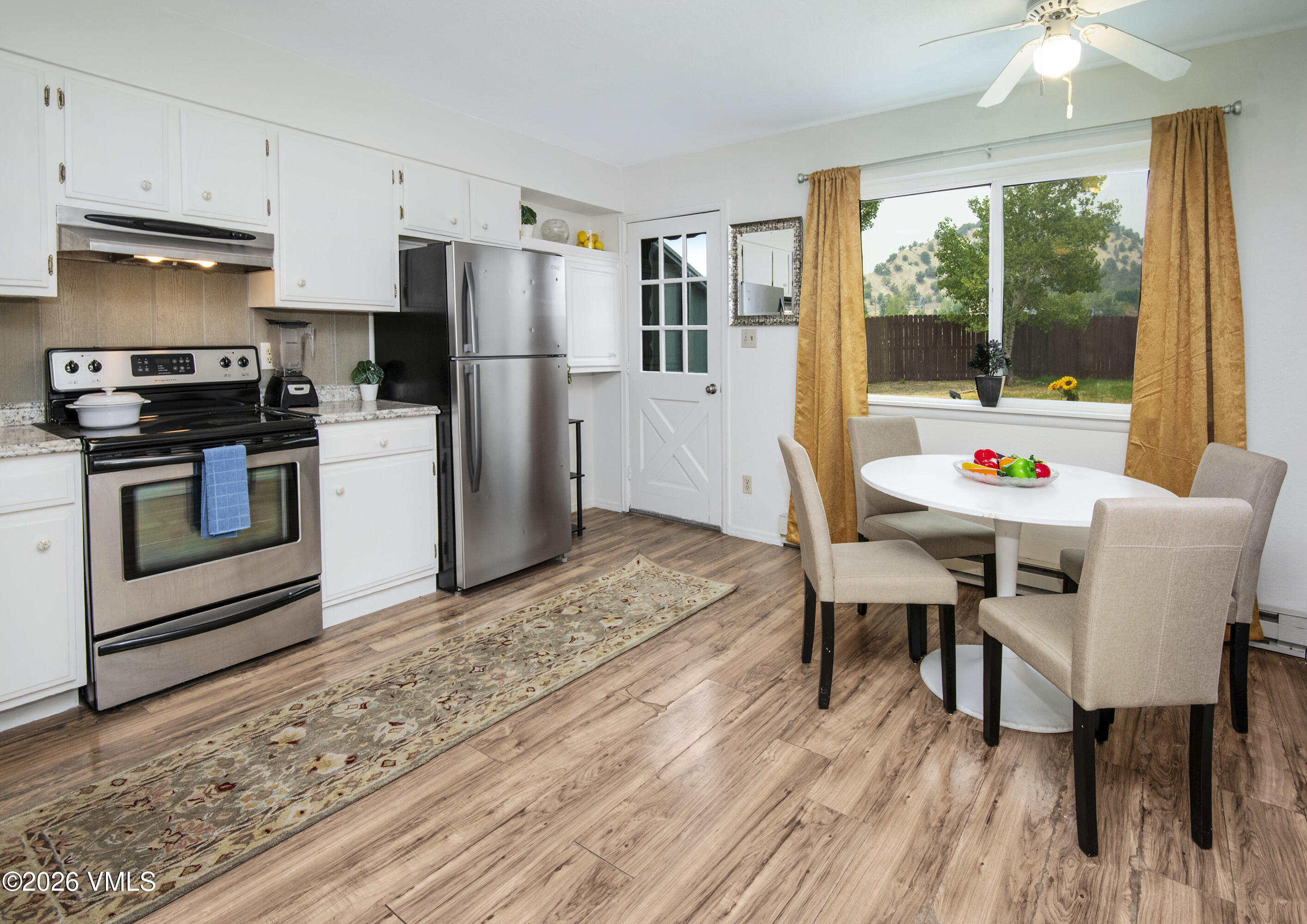 85 Chambers Avenue, Unit 10 Eagle, CO 81631 - Photo 4 of 41 a kitchen view of a dining table chairs and a refrigerator