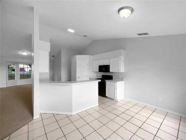 a kitchen with a sink cabinets and outdoor space