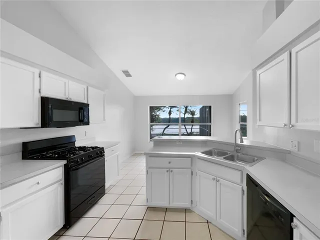 a kitchen with stainless steel appliances a sink stove and microwave