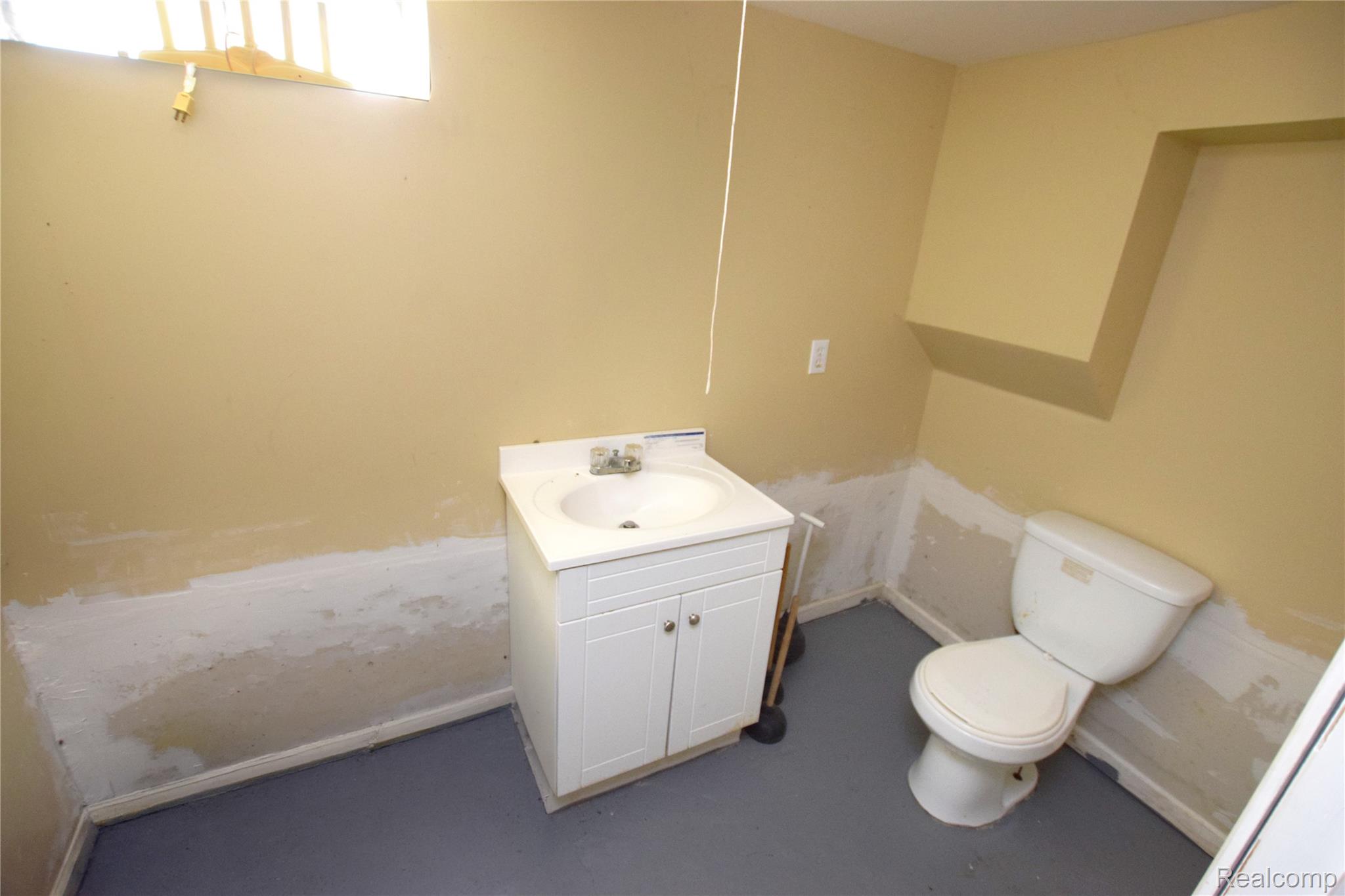4301 Pengelly Road Flint, MI 48507 - Photo 12 of 16 Half bathroom featuring vanity and concrete floors
