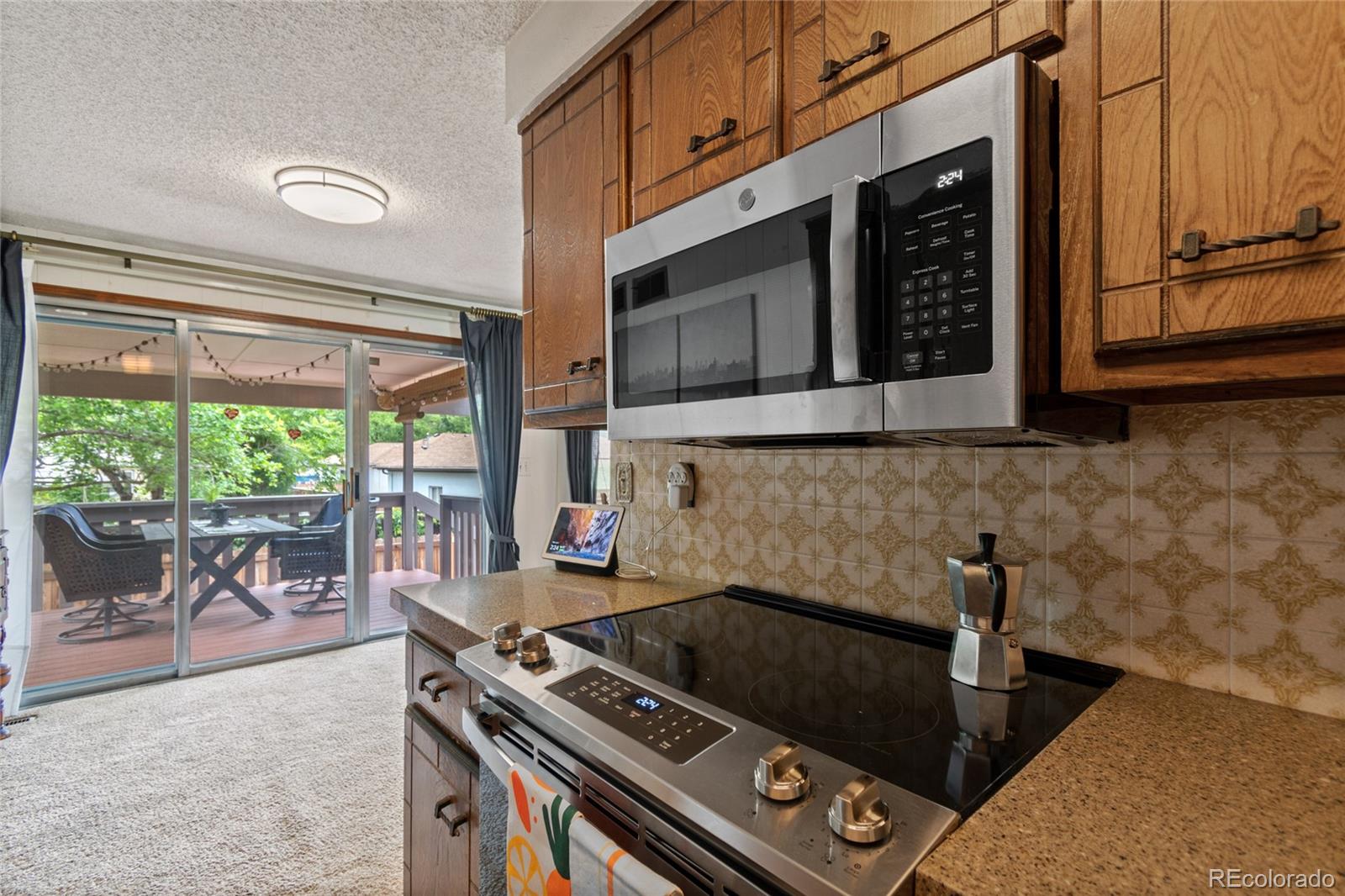 3315 Marshall Street Wheat Ridge, CO 80033 - Photo 11 of 30 a kitchen with a stove a sink and a microwave