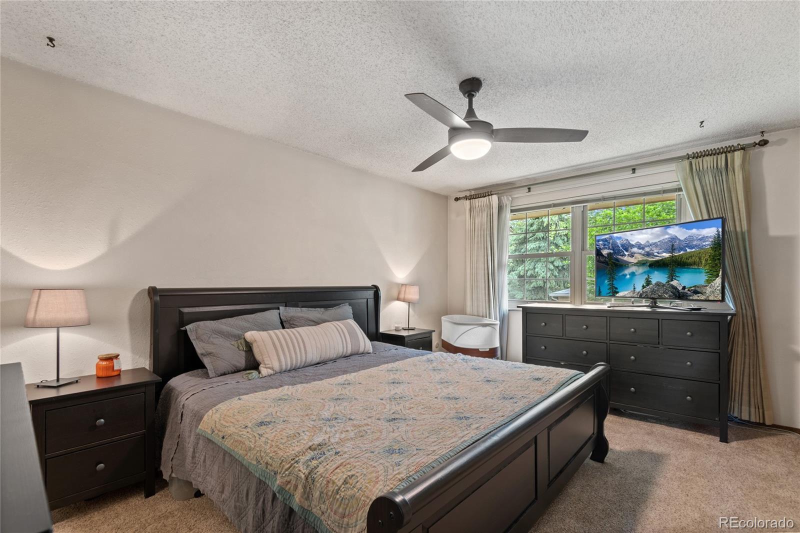 3315 Marshall Street Wheat Ridge, CO 80033 - Photo 14 of 30 a bedroom with a large bed and a window