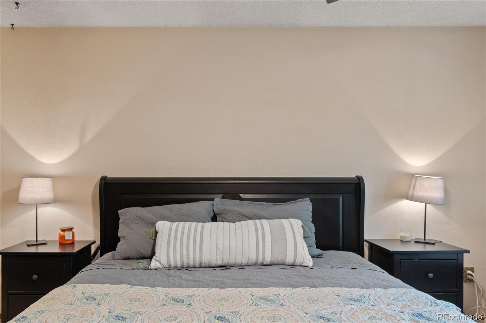 3315 Marshall Street Wheat Ridge, CO 80033 - Photo 16 of 30 a bedroom with a bed and a lamp