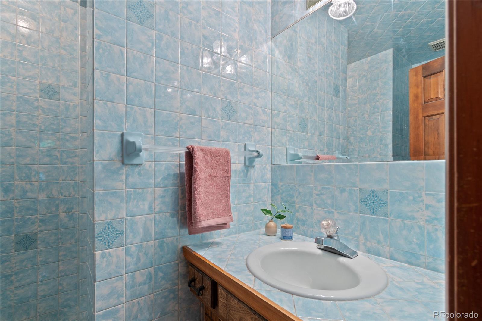 3315 Marshall Street Wheat Ridge, CO 80033 - Photo 17 of 30 a bathroom with a sink and a mirror