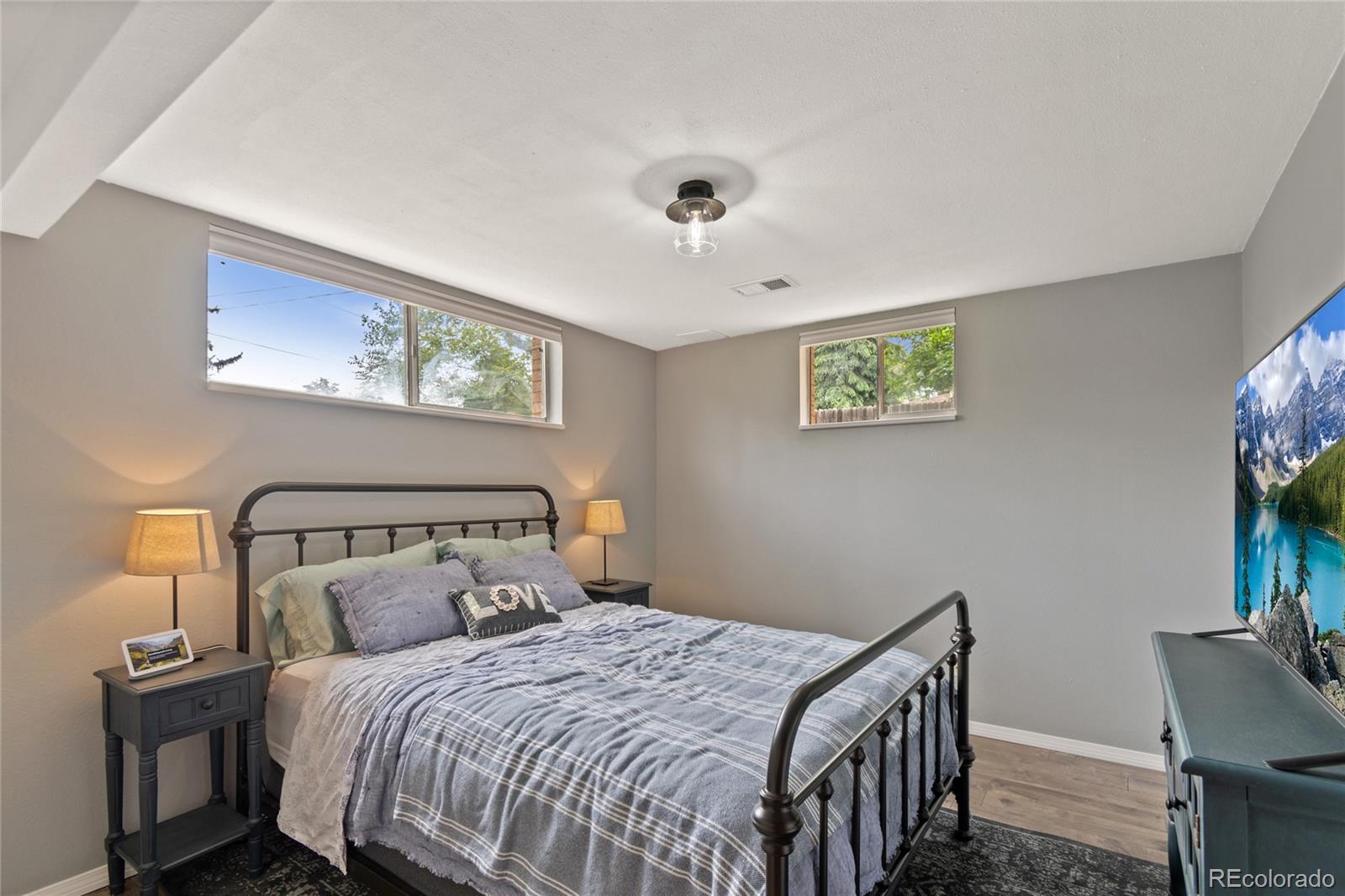 3315 Marshall Street Wheat Ridge, CO 80033 - Photo 19 of 30 a bedroom with a bed and a chandelier