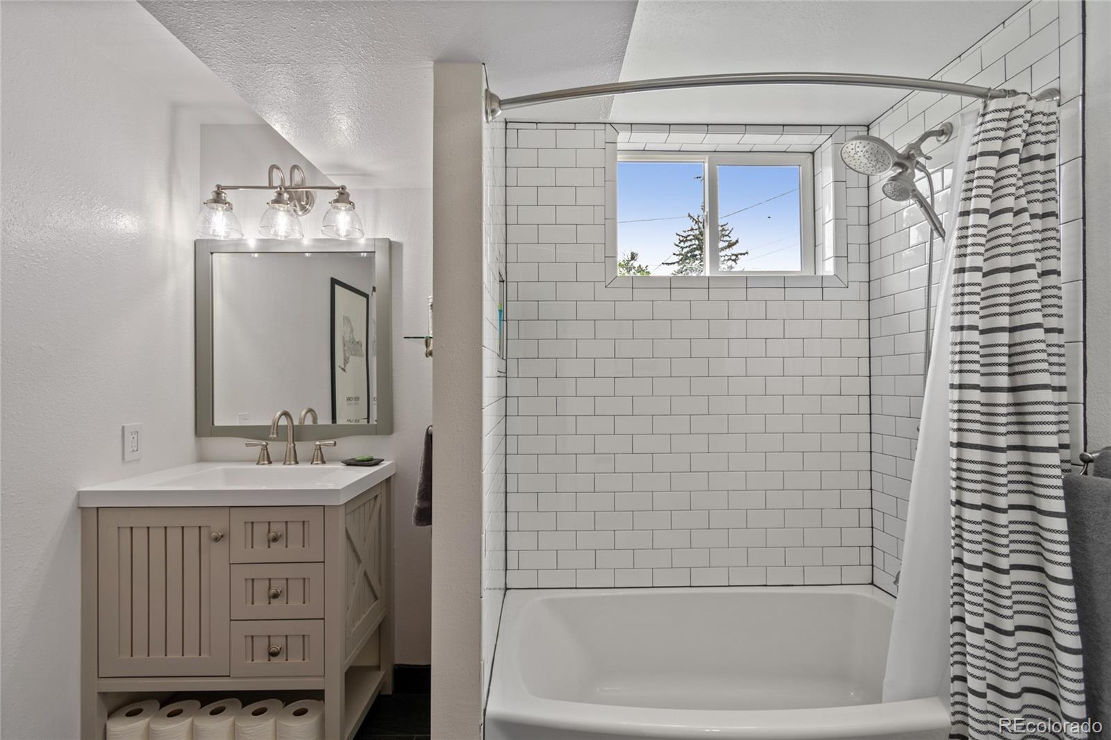 3315 Marshall Street Wheat Ridge, CO 80033 - Photo 20 of 30 a bathroom with a sink a vanity and a mirror
