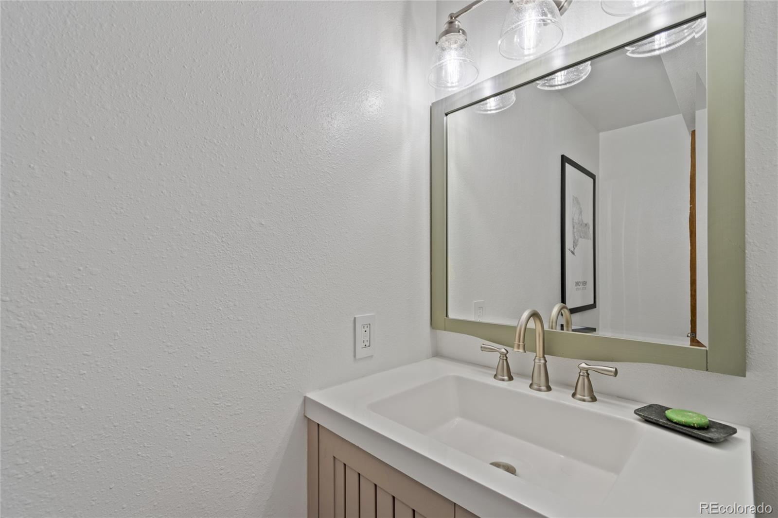 3315 Marshall Street Wheat Ridge, CO 80033 - Photo 22 of 30 a bathroom with a sink and a mirror