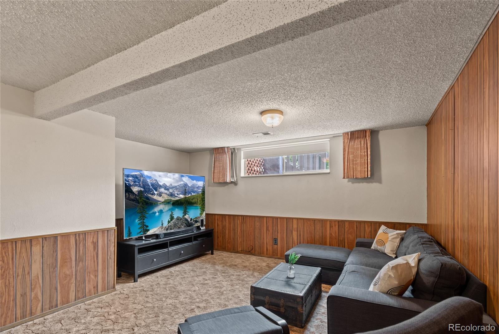 3315 Marshall Street Wheat Ridge, CO 80033 - Photo 24 of 30 a living room with furniture and a flat screen tv