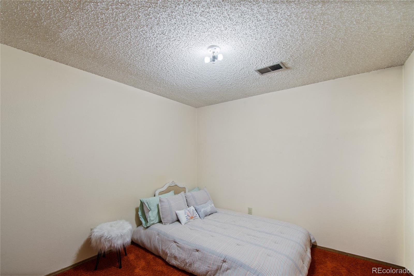 3315 Marshall Street Wheat Ridge, CO 80033 - Photo 25 of 30 a bedroom with a bed and a table