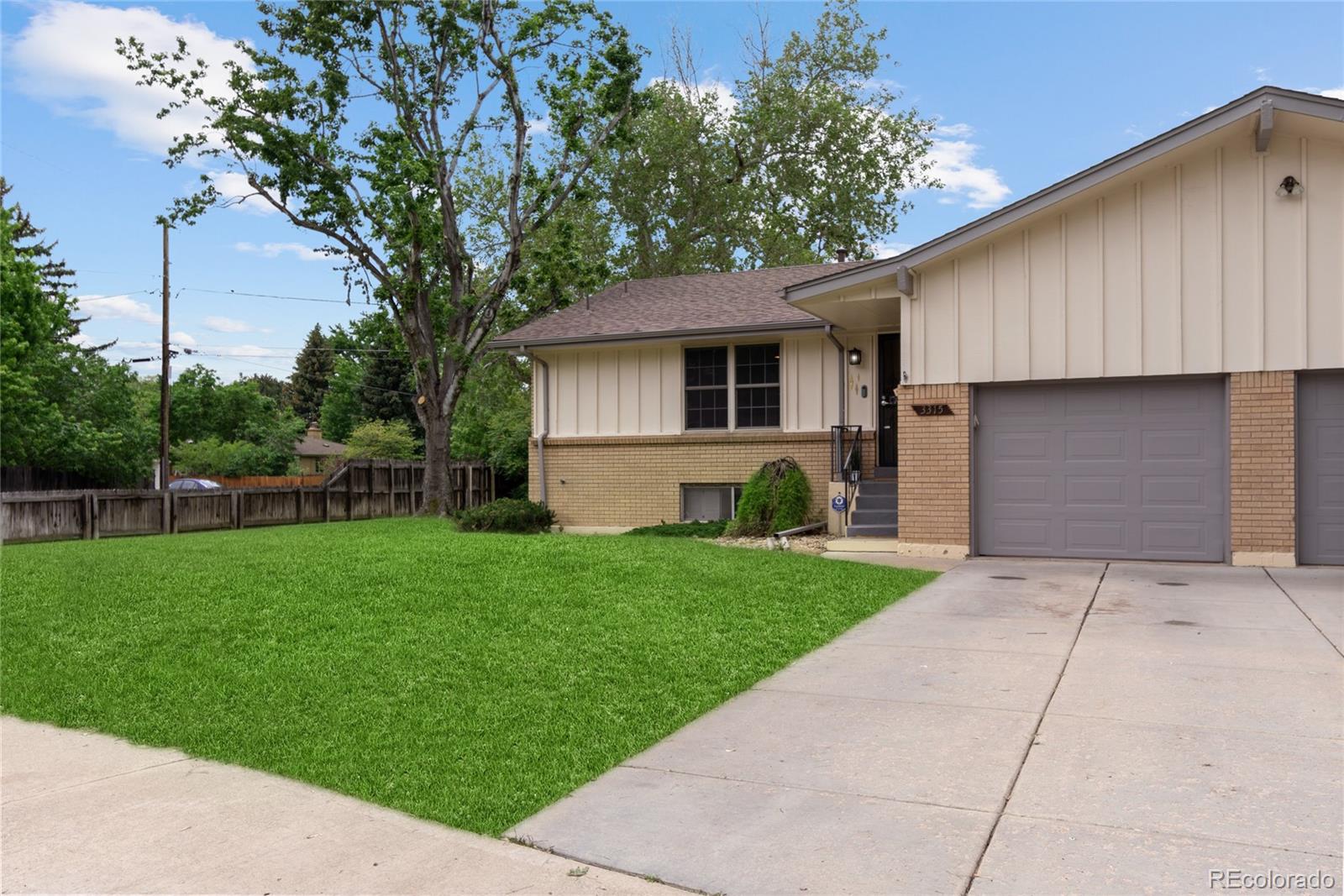 3315 Marshall Street Wheat Ridge, CO 80033 - Photo 3 of 30 a backyard of a house with plants and large tree