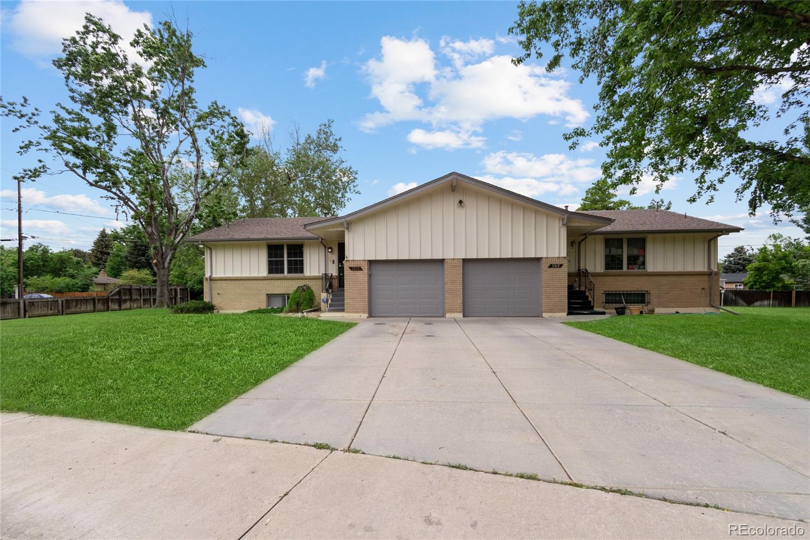 3315 Marshall Street Wheat Ridge, CO 80033 - Photo 4 of 30 a front view of a house with a yard and garage