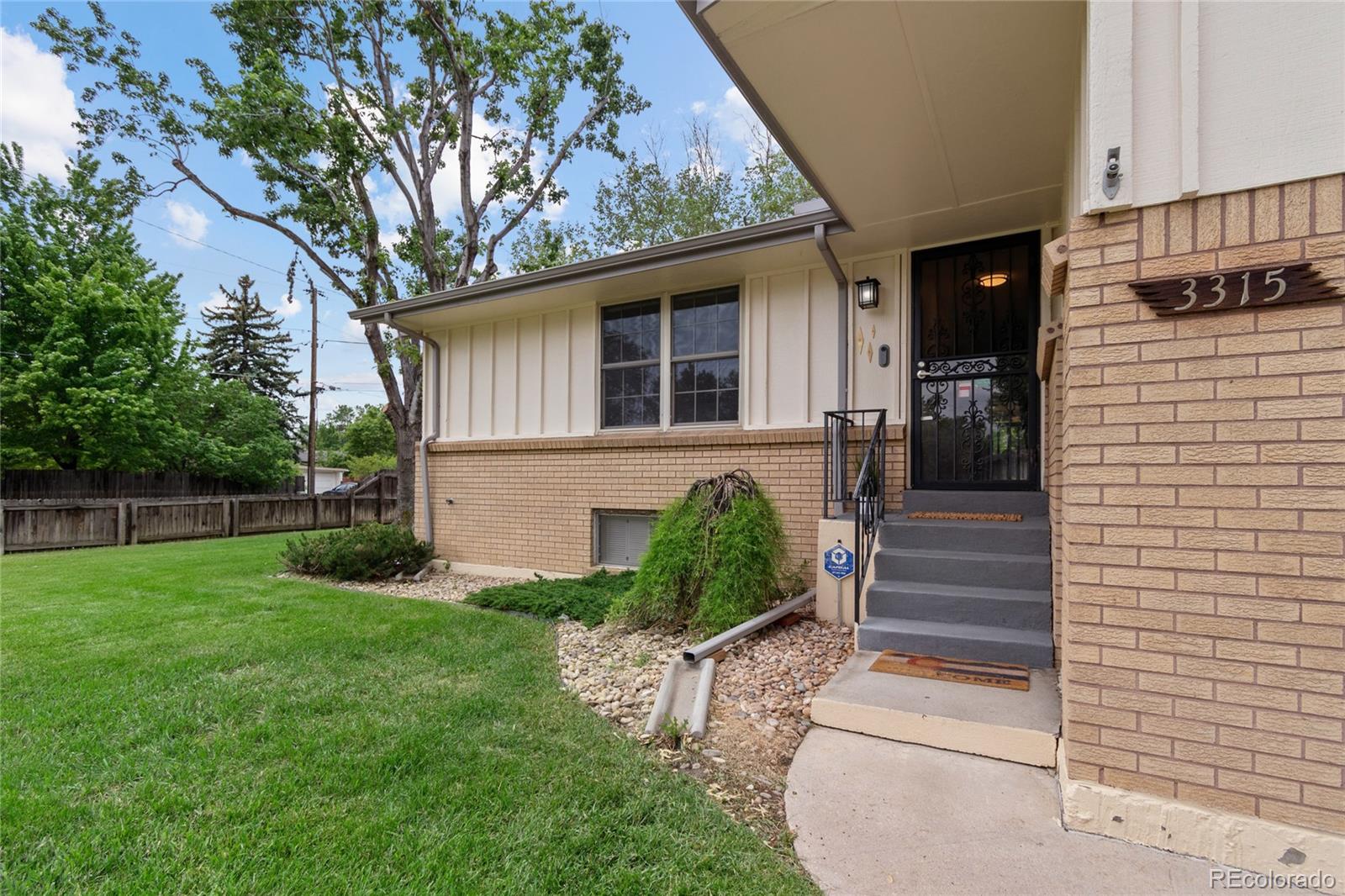 3315 Marshall Street Wheat Ridge, CO 80033 - Photo 5 of 30 a front view of a house with garden