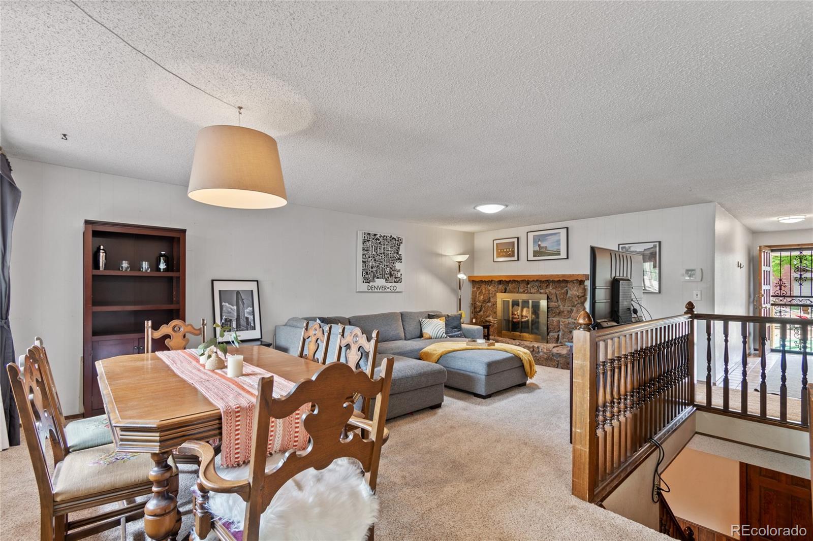 3315 Marshall Street Wheat Ridge, CO 80033 - Photo 8 of 30 a living room with furniture a fireplace and a flat screen tv