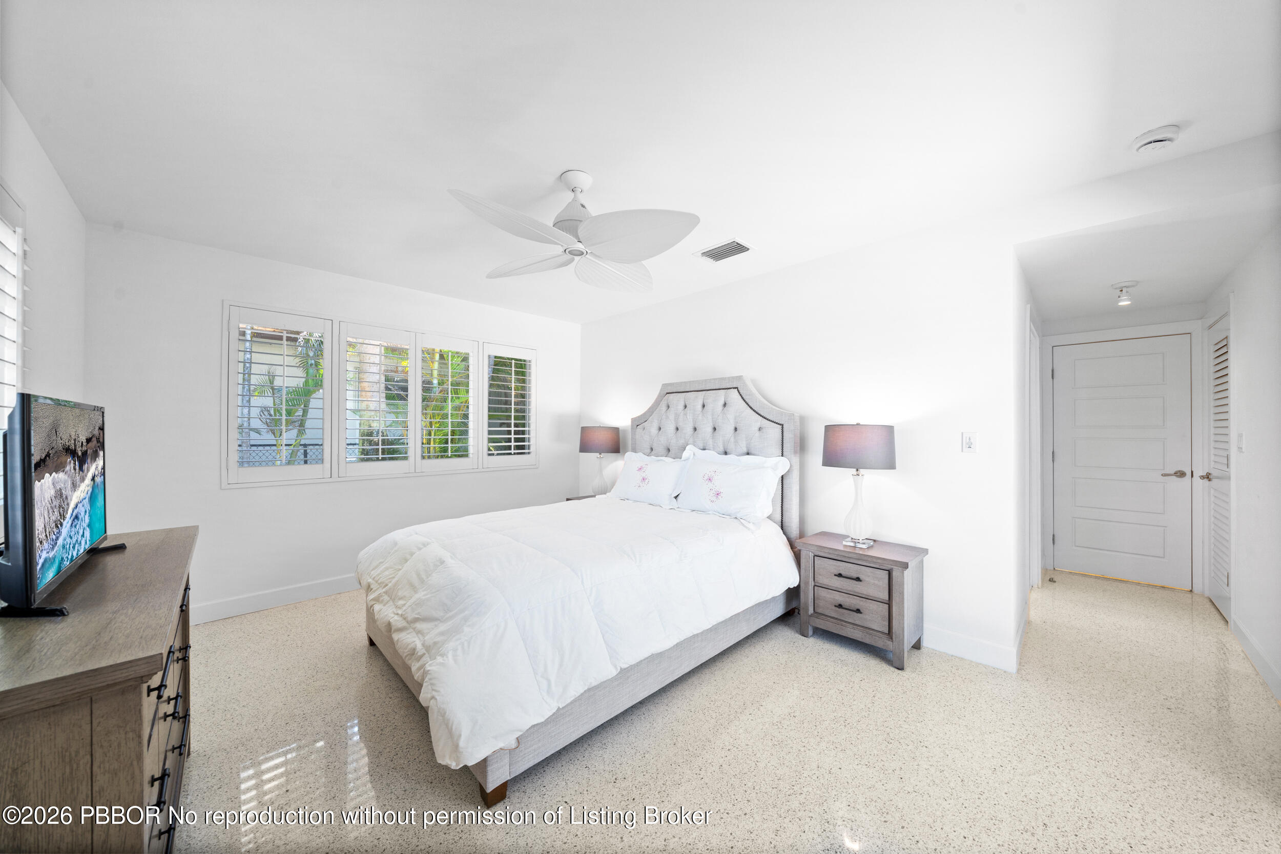 2259 Ibis Isle Road East, Unit E Palm Beach, FL 33480 - Photo 9 of 28 a bedroom with a bed and a flat screen tv