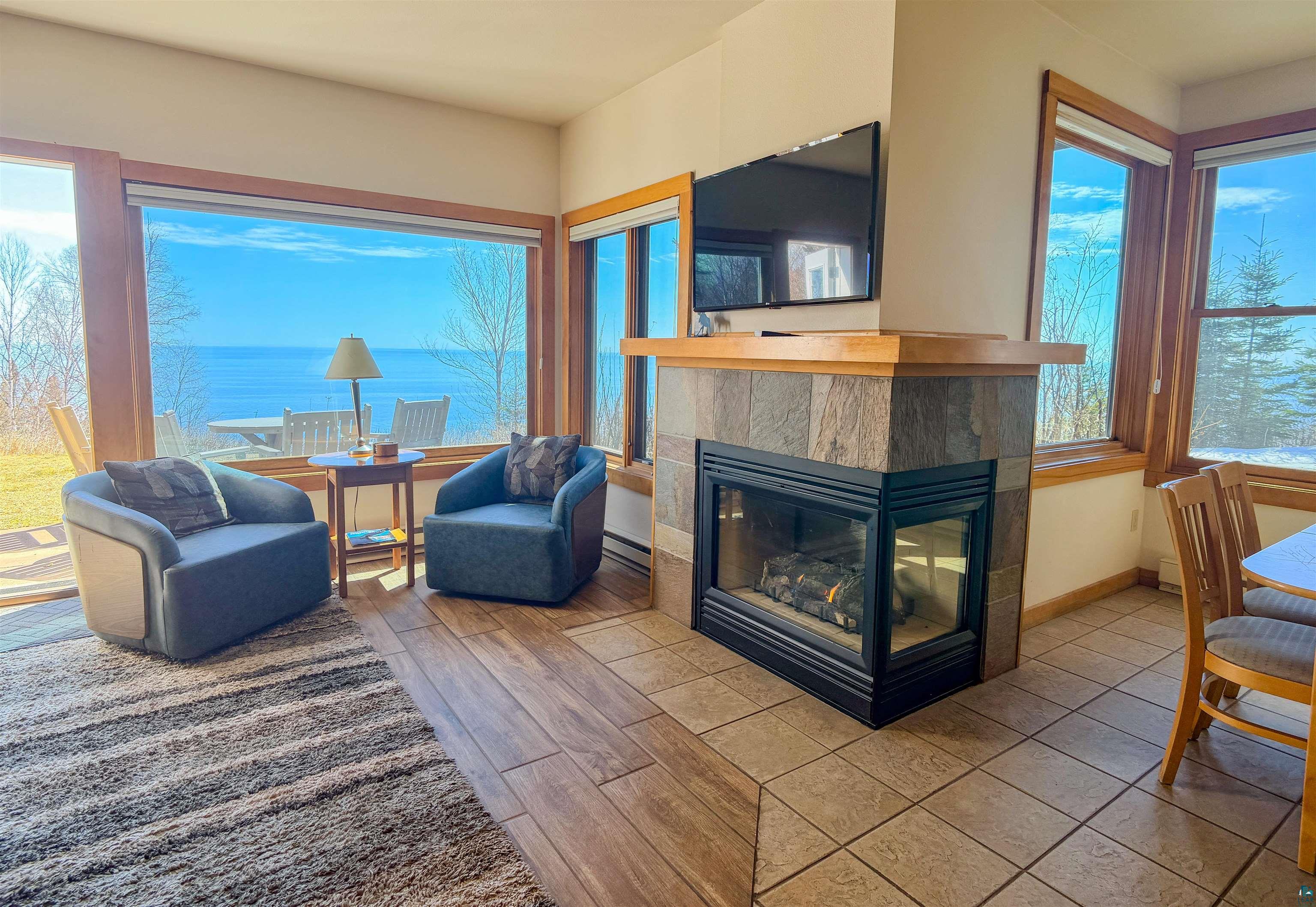504-506 Poplar River Road, Unit 505 Lutsen, MN 55612 - Photo 33 of 39 Living area featuring a gas fireplace with stone tile surround and a wood mantel