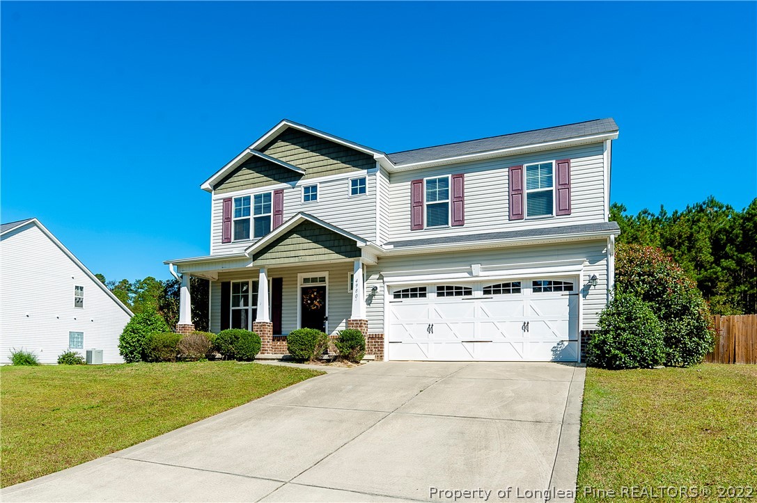 4980 Aberdeen Road Raeford, NC 28376 - Photo 1 of 38 a front view of a house with a yard and garage