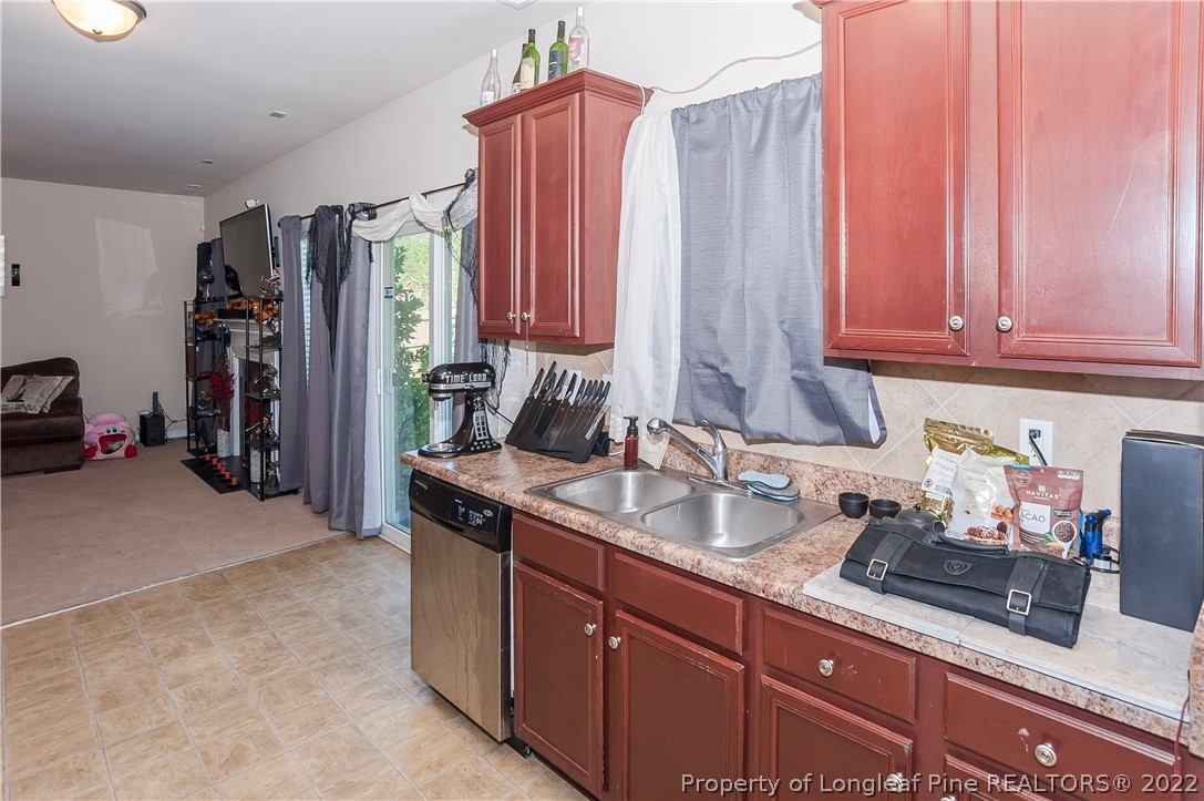 4980 Aberdeen Road Raeford, NC 28376 - Photo 12 of 38 a kitchen with stainless steel appliances granite countertop a refrigerator and a sink