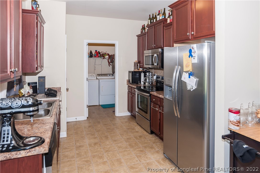 4980 Aberdeen Road Raeford, NC 28376 - Photo 13 of 38 a kitchen with stainless steel appliances granite countertop a refrigerator and a stove
