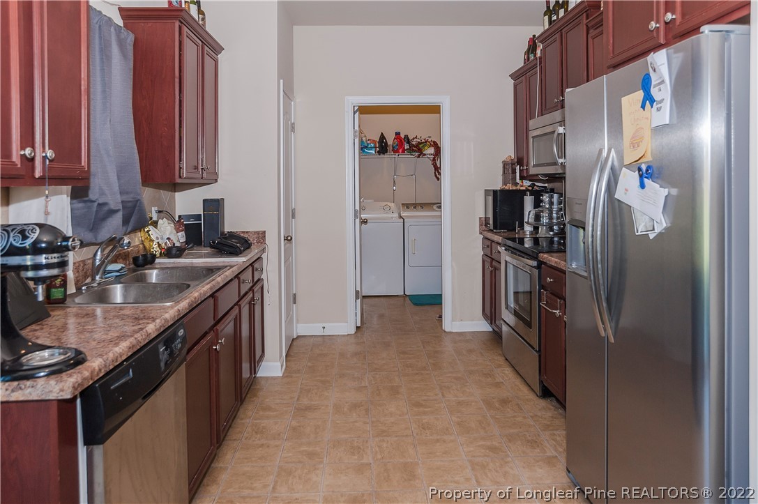 4980 Aberdeen Road Raeford, NC 28376 - Photo 15 of 38 a kitchen with stainless steel appliances granite countertop a refrigerator a stove and a sink