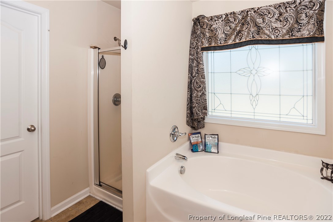 4980 Aberdeen Road Raeford, NC 28376 - Photo 24 of 38 a white bath tub sitting next to a window