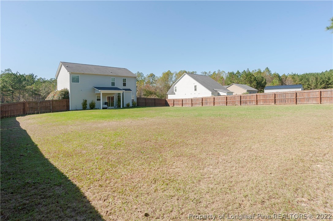 4980 Aberdeen Road Raeford, NC 28376 - Photo 36 of 38 a view of a house with a yard and a large tree