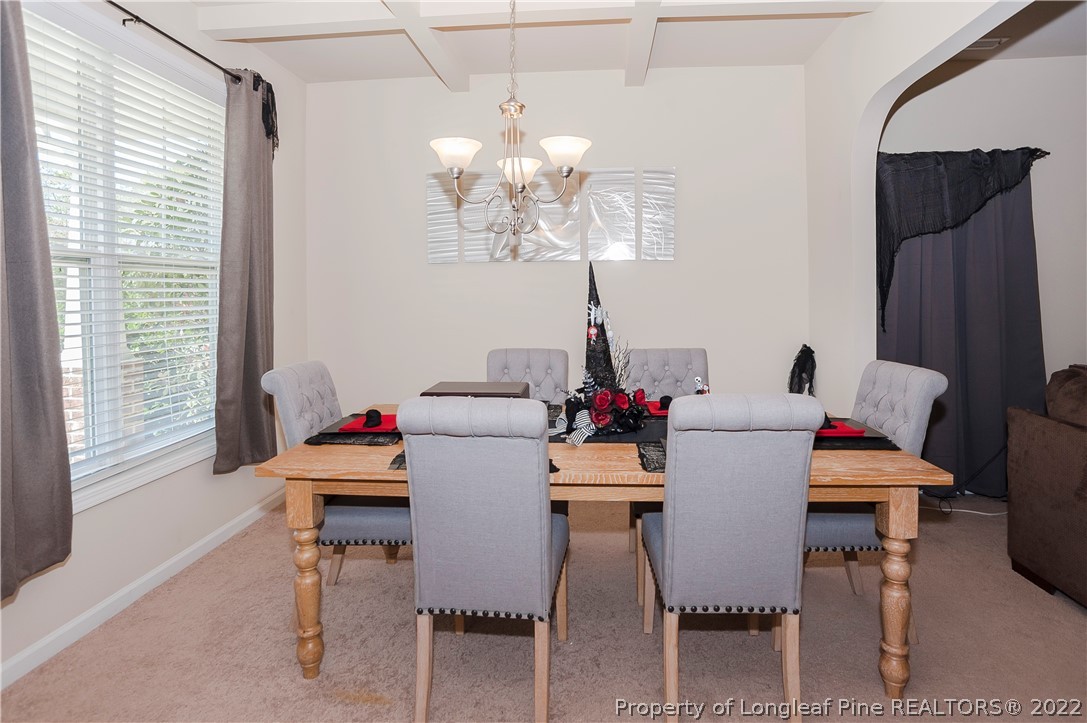 4980 Aberdeen Road Raeford, NC 28376 - Photo 7 of 38 a dining room with furniture a chandelier and window