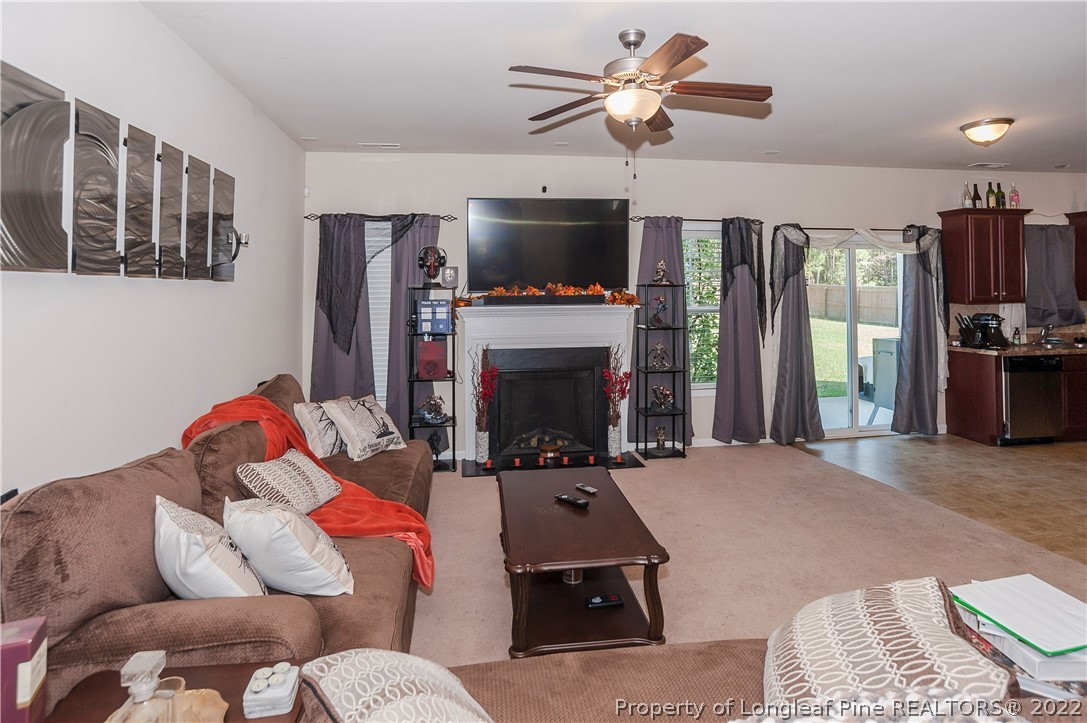 4980 Aberdeen Road Raeford, NC 28376 - Photo 9 of 38 a living room with furniture a flat screen tv and a fireplace