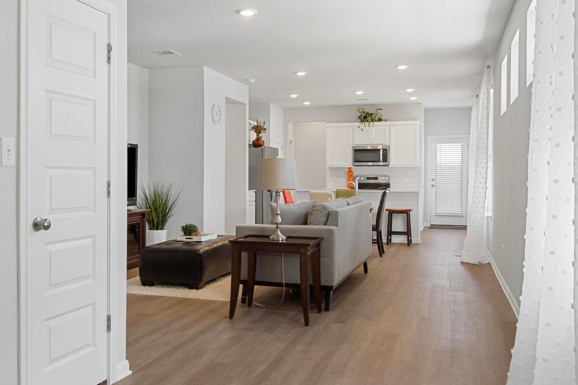 149 Cutleaf, Unit 31 San Marcos, TX 78666 - Photo 11 of 11 a workspace with wooden floor and a bathroom