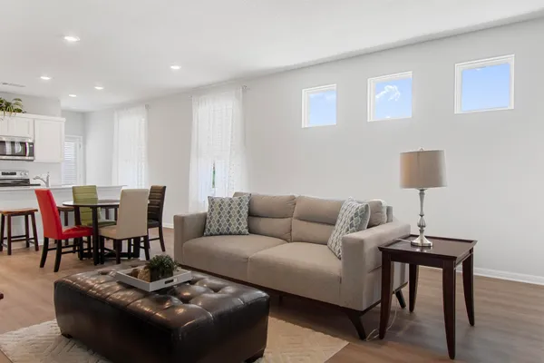 a living room with furniture and a lamp