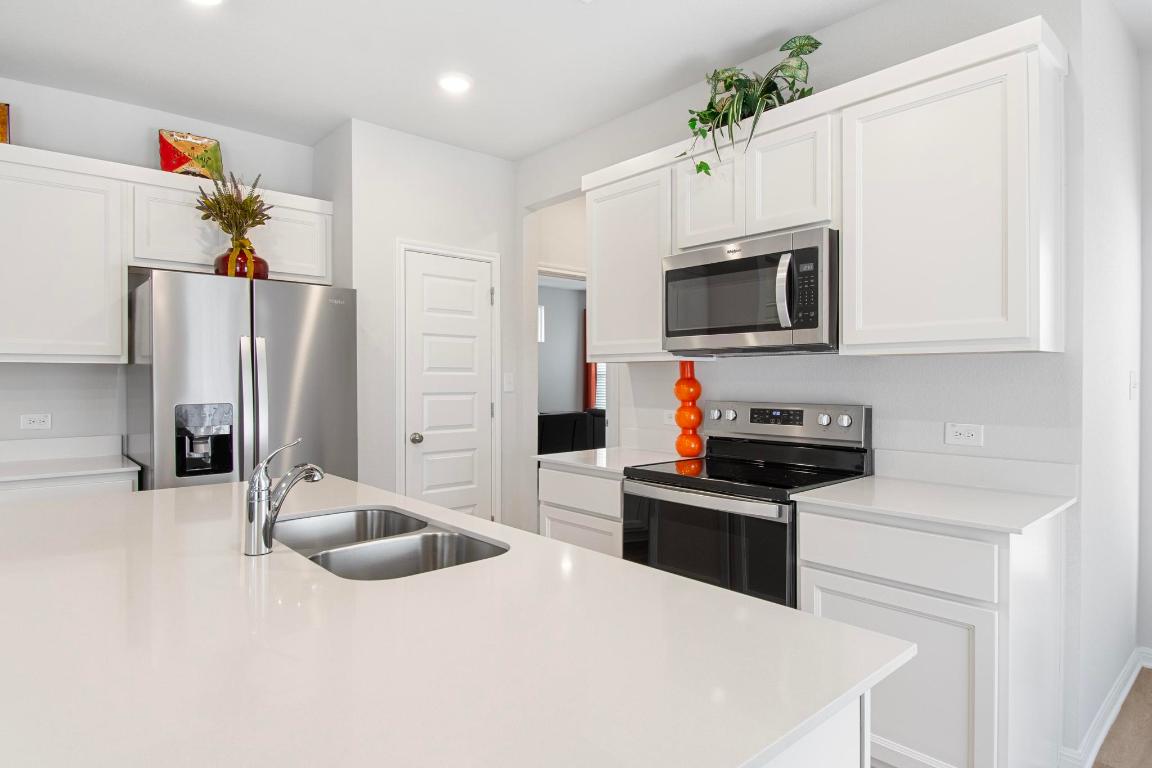 149 Cutleaf, Unit 31 San Marcos, TX 78666 - Photo 6 of 11 a kitchen with stainless steel appliances a stove microwave and refrigerator
