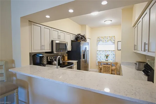 a kitchen with stainless steel appliances a microwave a stove and refrigerator
